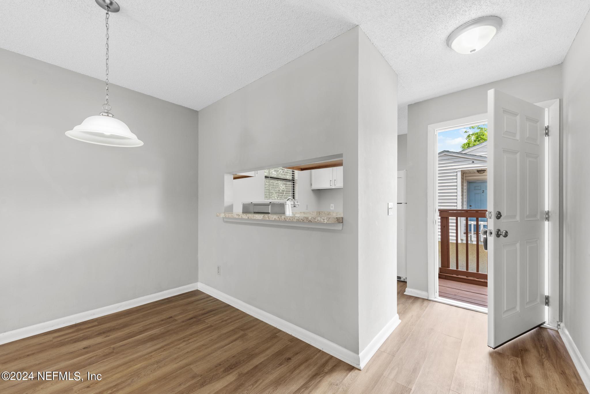 3604 Morton Street, Unit 2 Jacksonville, FL 32217 - Photo 3 of 22 an empty room with wooden floor and windows
