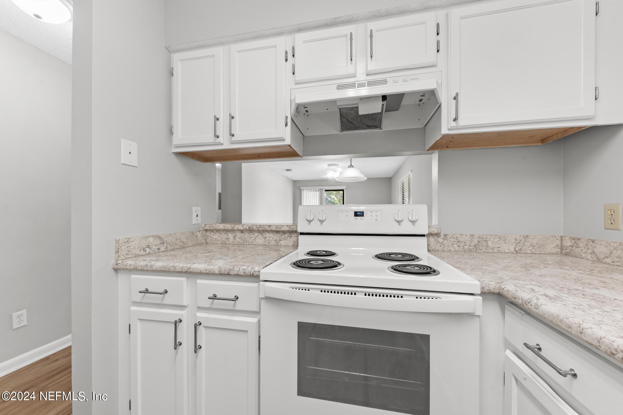 3604 Morton Street, Unit 2 Jacksonville, FL 32217 - Photo 5 of 22 a kitchen with granite countertop white cabinets and white appliances