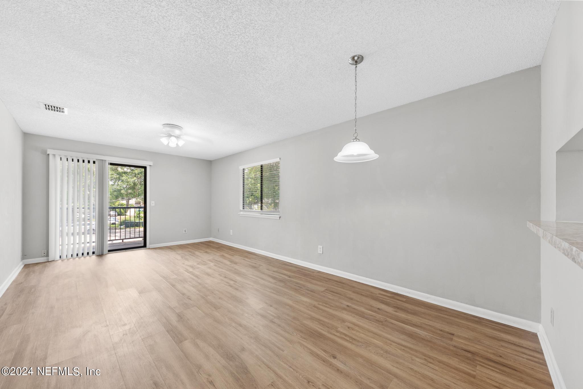 3604 Morton Street, Unit 2 Jacksonville, FL 32217 - Photo 7 of 22 a view of an empty room with window and wooden floor