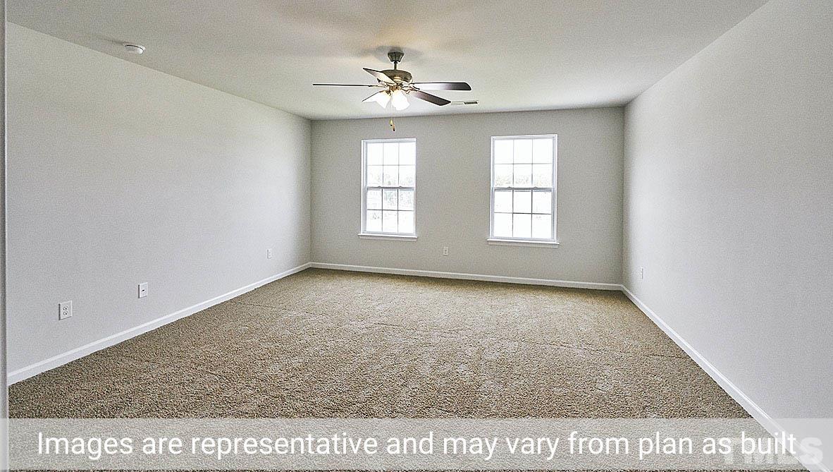 278 Water Wheel Road Rocky Mount, NC 27803 - Photo 12 of 20 an empty room with windows and chandelier fan