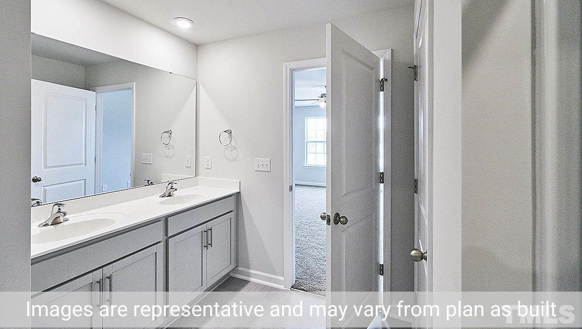278 Water Wheel Road Rocky Mount, NC 27803 - Photo 14 of 20 a bathroom with a sink a mirror and a shower