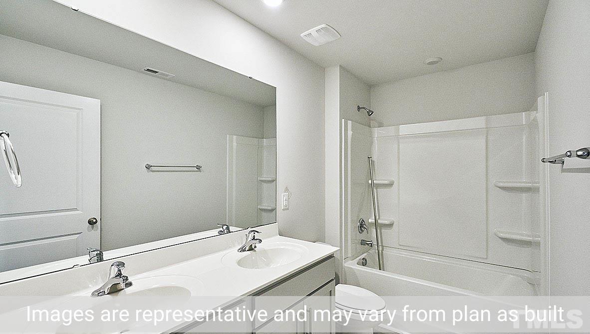 278 Water Wheel Road Rocky Mount, NC 27803 - Photo 18 of 20 a bathroom with a tub a sink and mirror