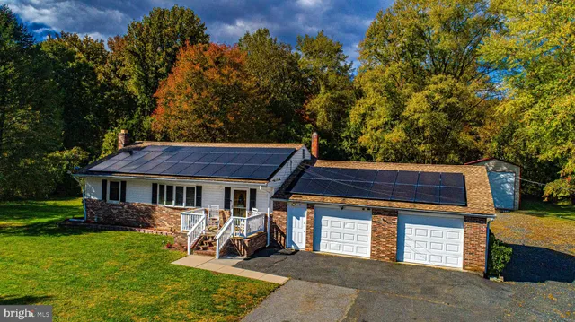 a view of a house with backyard porch and sitting area