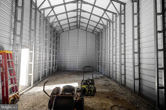 a backyard of a house with chairs