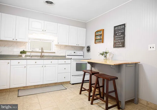 a kitchen with a sink cabinets and window