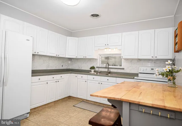 a kitchen with stainless steel appliances granite countertop a sink and cabinets