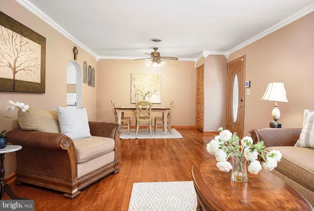 a living room with furniture and a chandelier