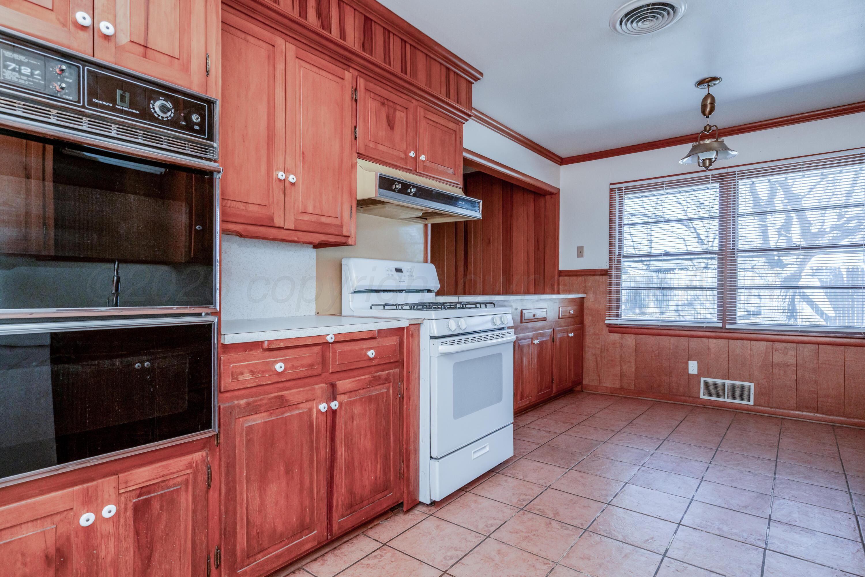 3308 Sunlite Street Amarillo, TX 79106 - Photo 13 of 37 a kitchen with stainless steel appliances a stove sink and cabinets