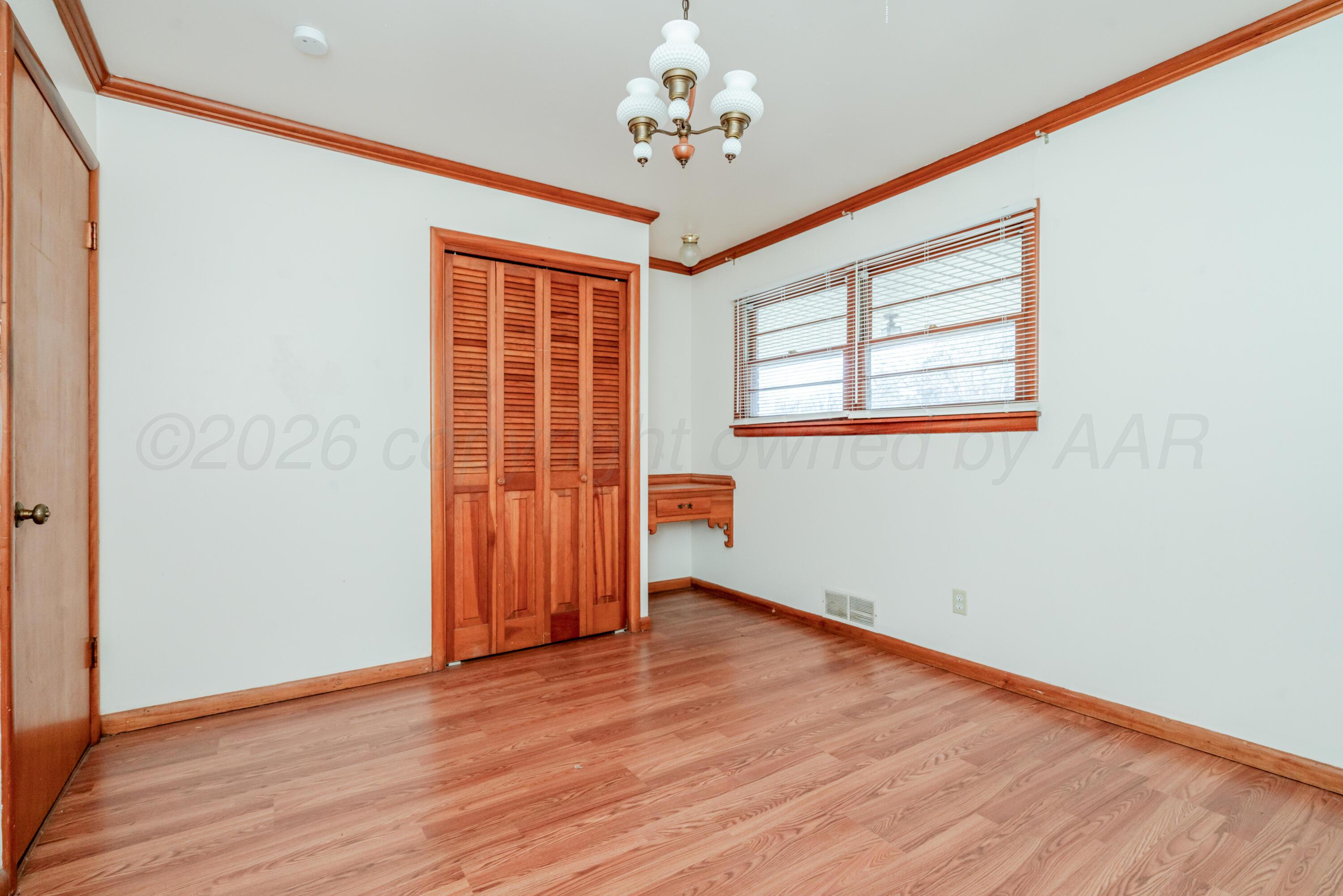 3308 Sunlite Street Amarillo, TX 79106 - Photo 16 of 37 a view of an empty room with wooden floor and a window