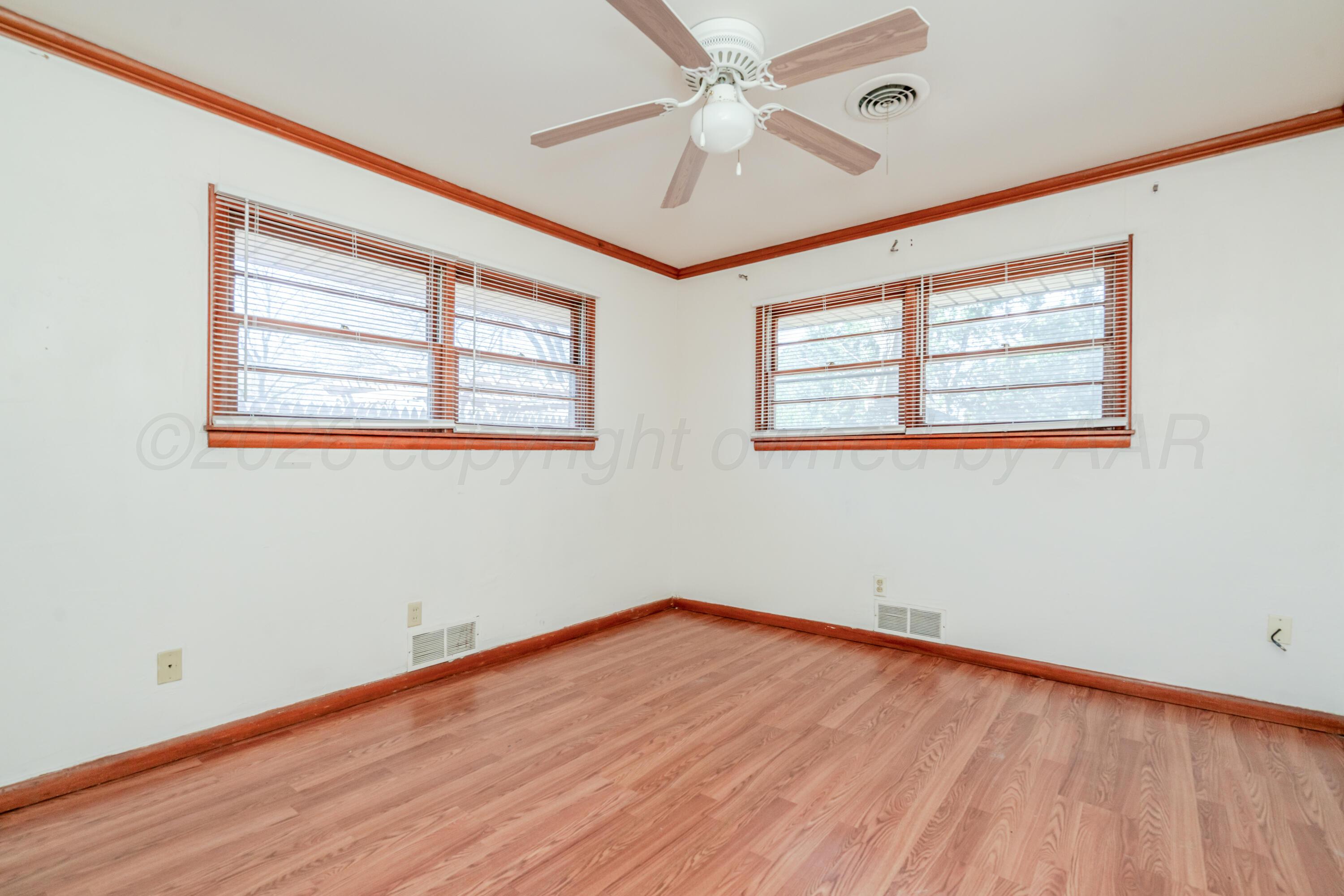 3308 Sunlite Street Amarillo, TX 79106 - Photo 18 of 37 a view of empty room with wooden floor and fan