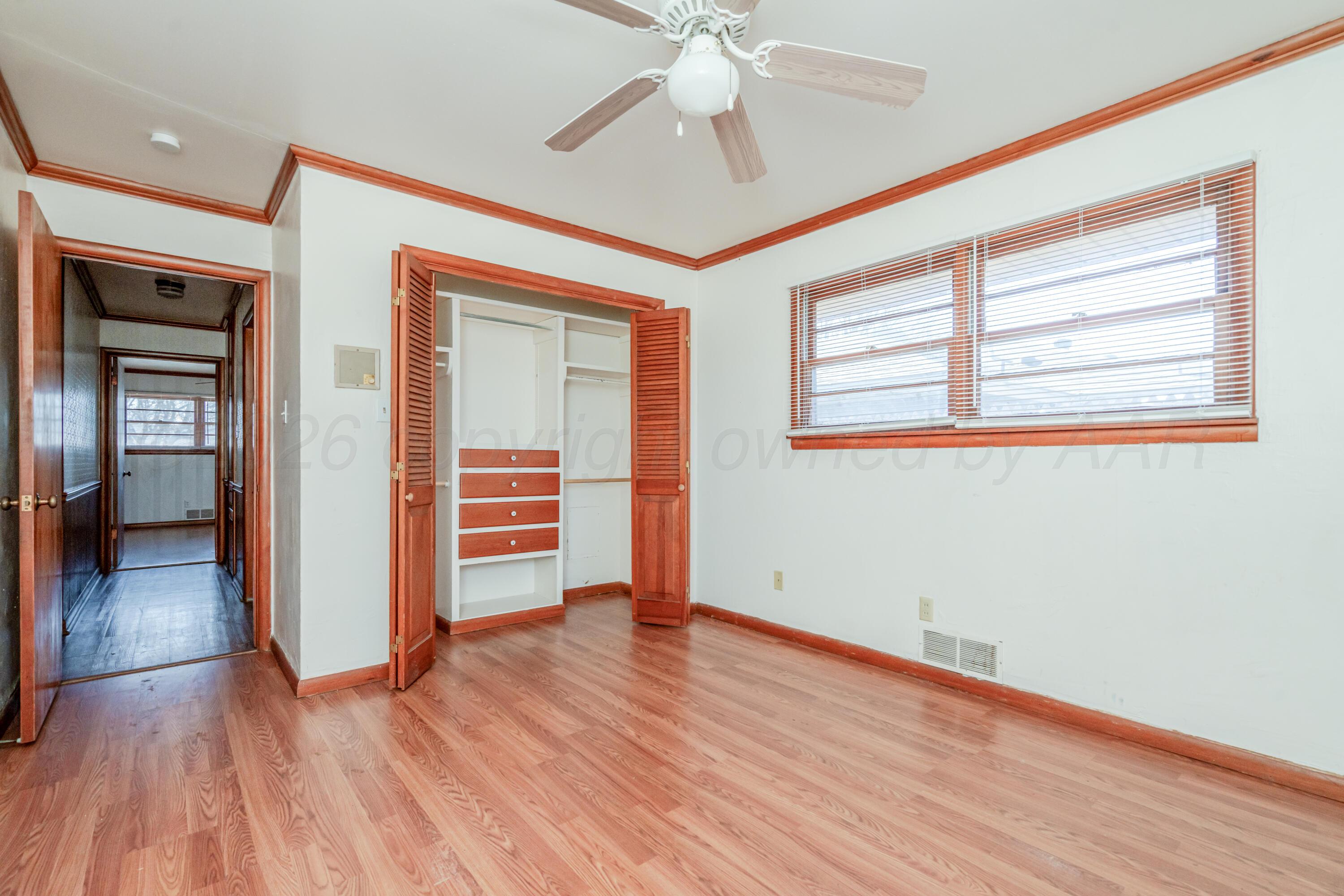3308 Sunlite Street Amarillo, TX 79106 - Photo 23 of 37 an empty room with wooden floor closet and windows