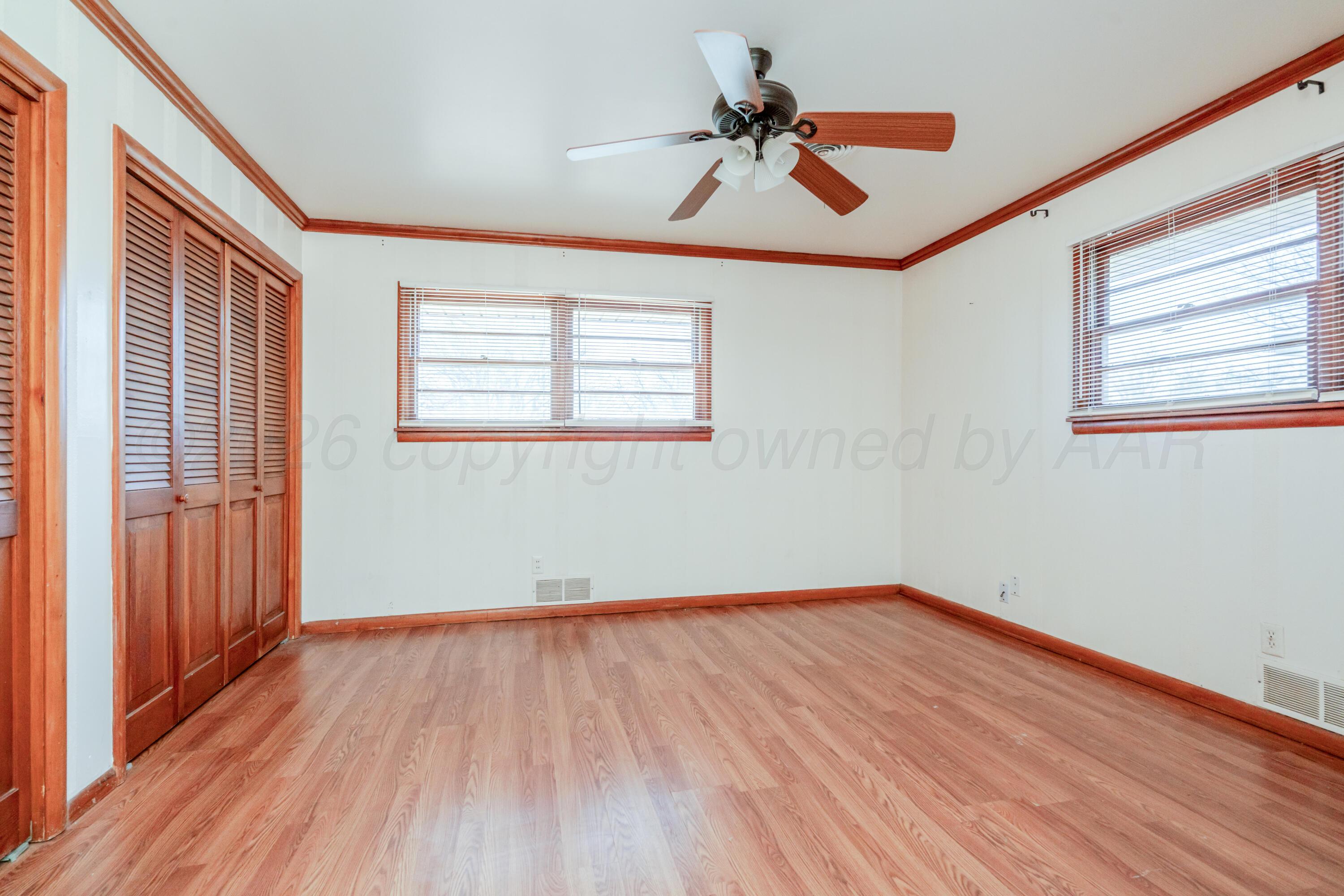 3308 Sunlite Street Amarillo, TX 79106 - Photo 25 of 37 a view of empty room with wooden floor and fan
