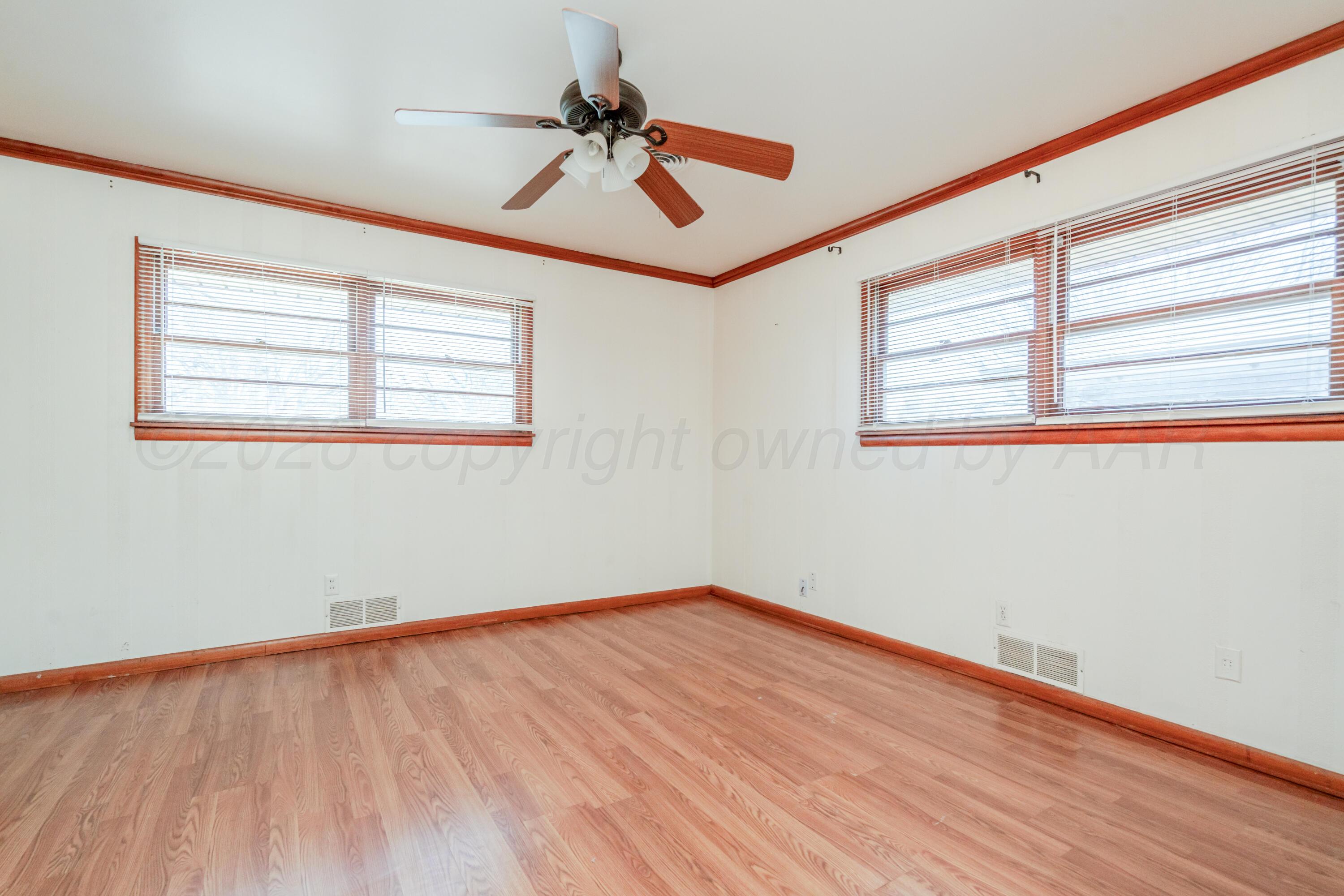 3308 Sunlite Street Amarillo, TX 79106 - Photo 26 of 37 a view of empty room with wooden floor and fan