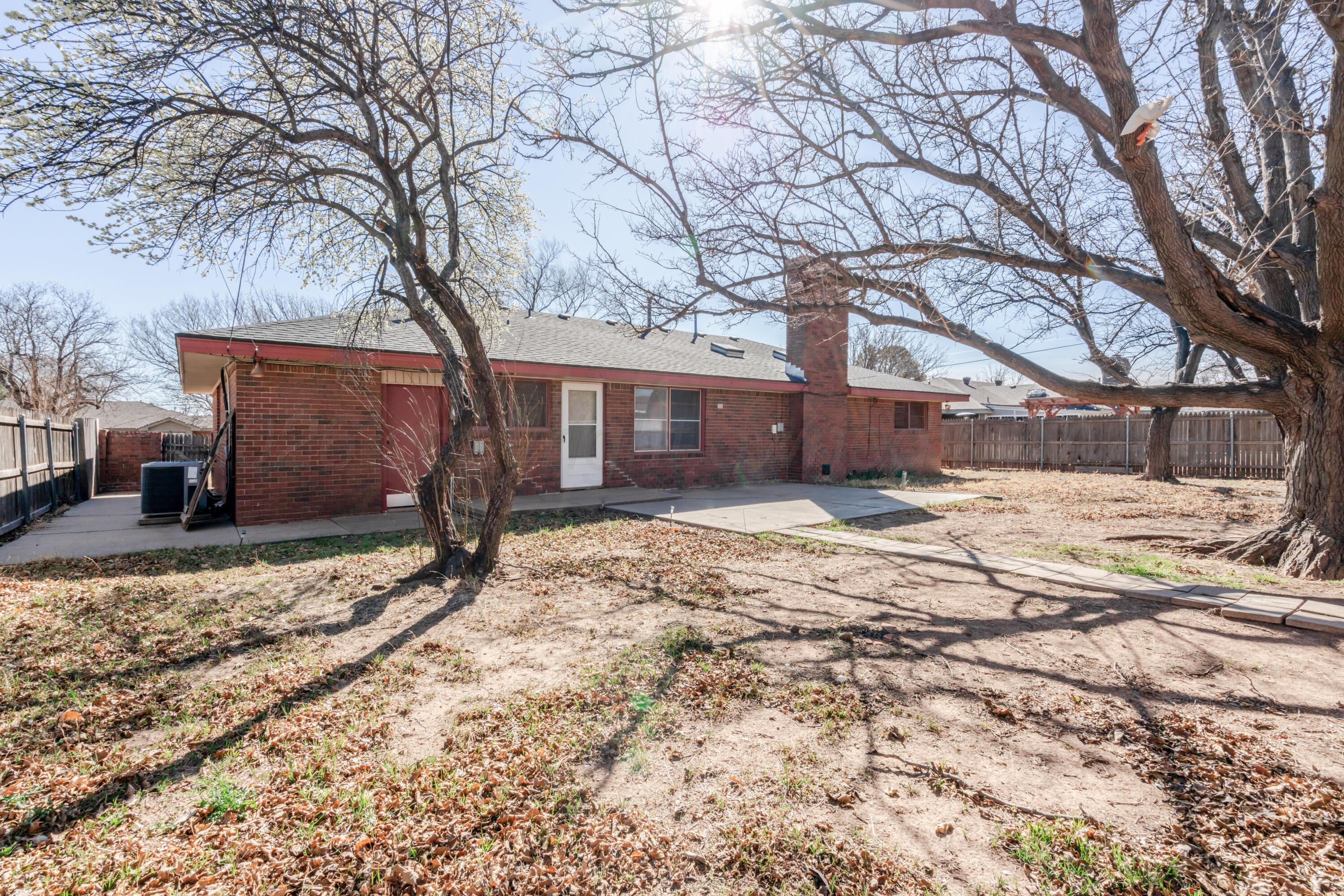 3308 Sunlite Street Amarillo, TX 79106 - Photo 32 of 37 a house that has a tree in front of it