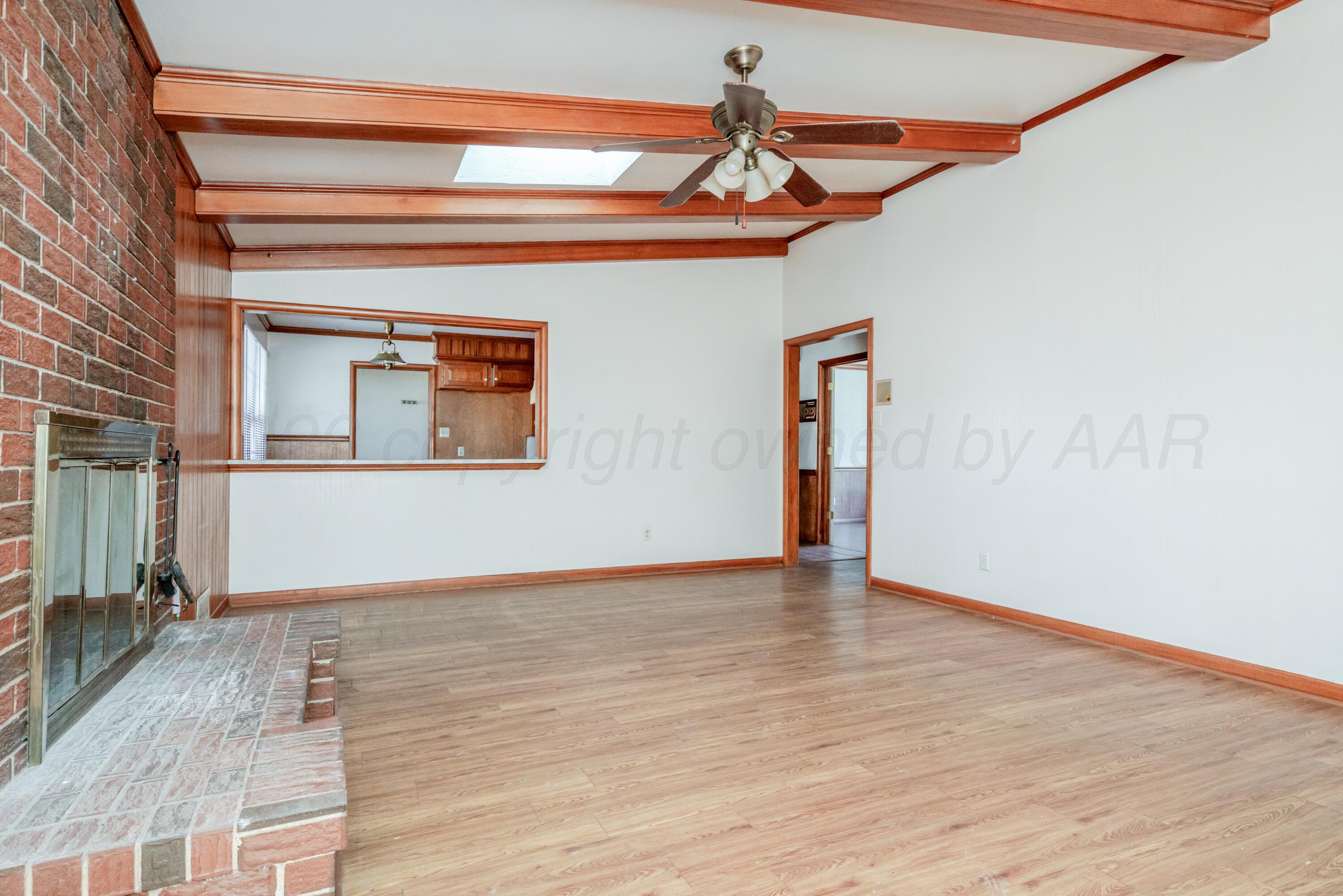 3308 Sunlite Street Amarillo, TX 79106 - Photo 8 of 37 a view of an empty room with wooden floor and a ceiling fan