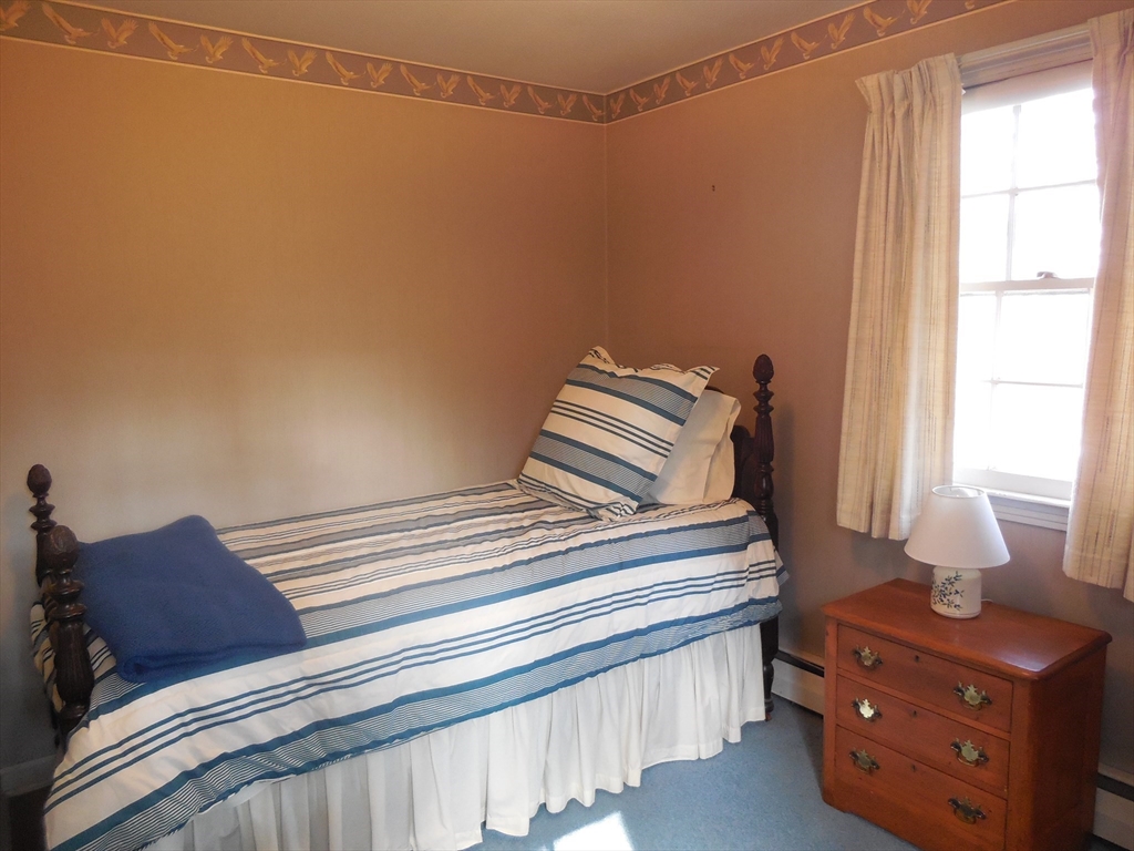 108 West Meadowview Road Holyoke, MA 01040 - Photo 16 of 18 a bedroom with a bed and wooden floor