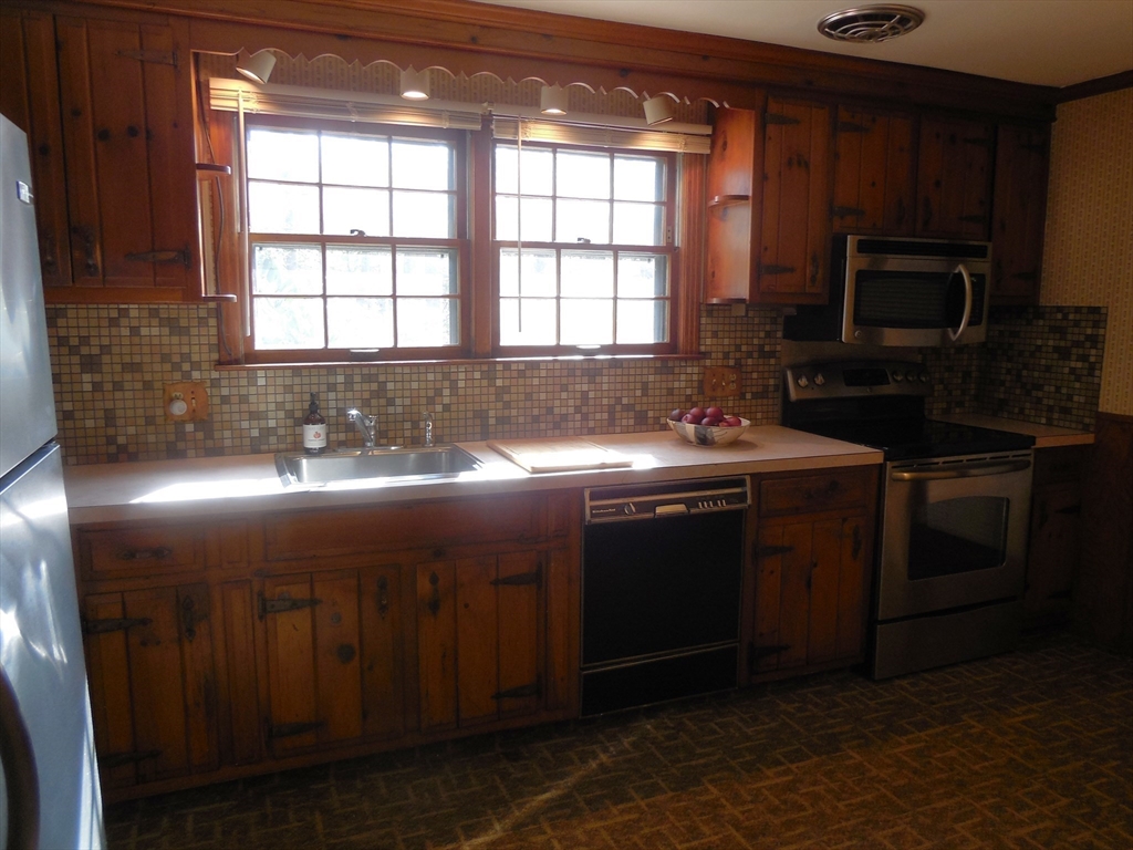 108 West Meadowview Road Holyoke, MA 01040 - Photo 8 of 18 a kitchen with a sink stove and microwave