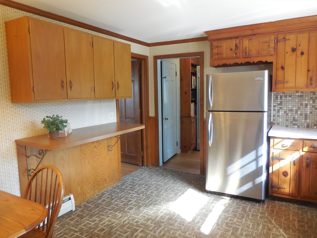 108 West Meadowview Road Holyoke, MA 01040 - Photo 9 of 18 a view of a refrigerator in kitchen and an empty room