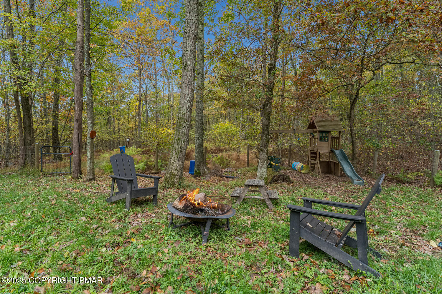 1187 Manzanedo Road East Stroudsburg, PA 18302 - Photo 20 of 31 a view of a backyard with lawn chairs and a fire pit