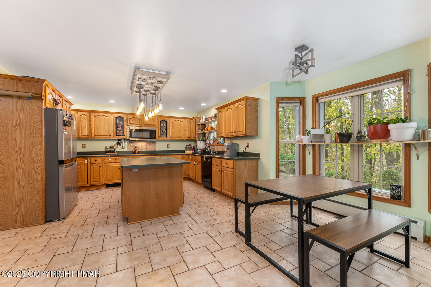 1187 Manzanedo Road East Stroudsburg, PA 18302 - Photo 5 of 31 a kitchen with stainless steel appliances kitchen island granite countertop a table chairs and a refrigerator
