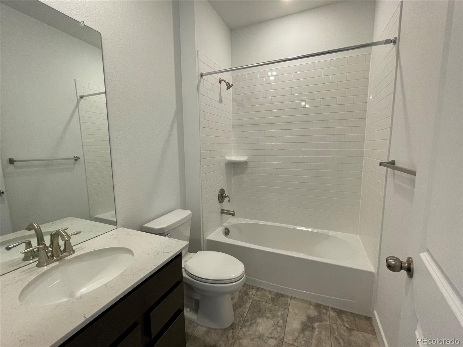 4598 Windmill Drive Brighton, CO 80601 - Photo 6 of 21 a bathroom with a sink toilet and shower