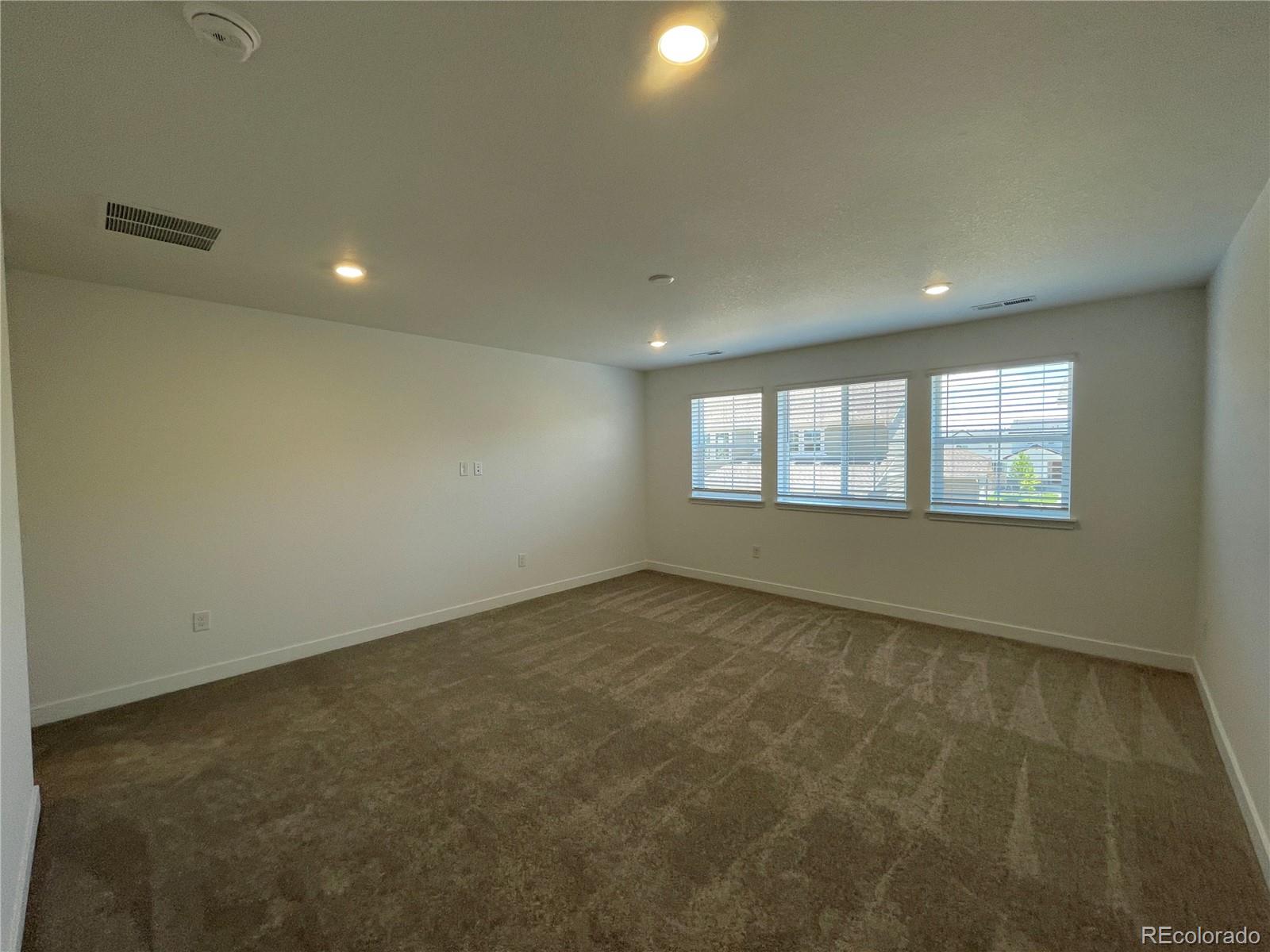 4598 Windmill Drive Brighton, CO 80601 - Photo 7 of 21 an empty room with windows