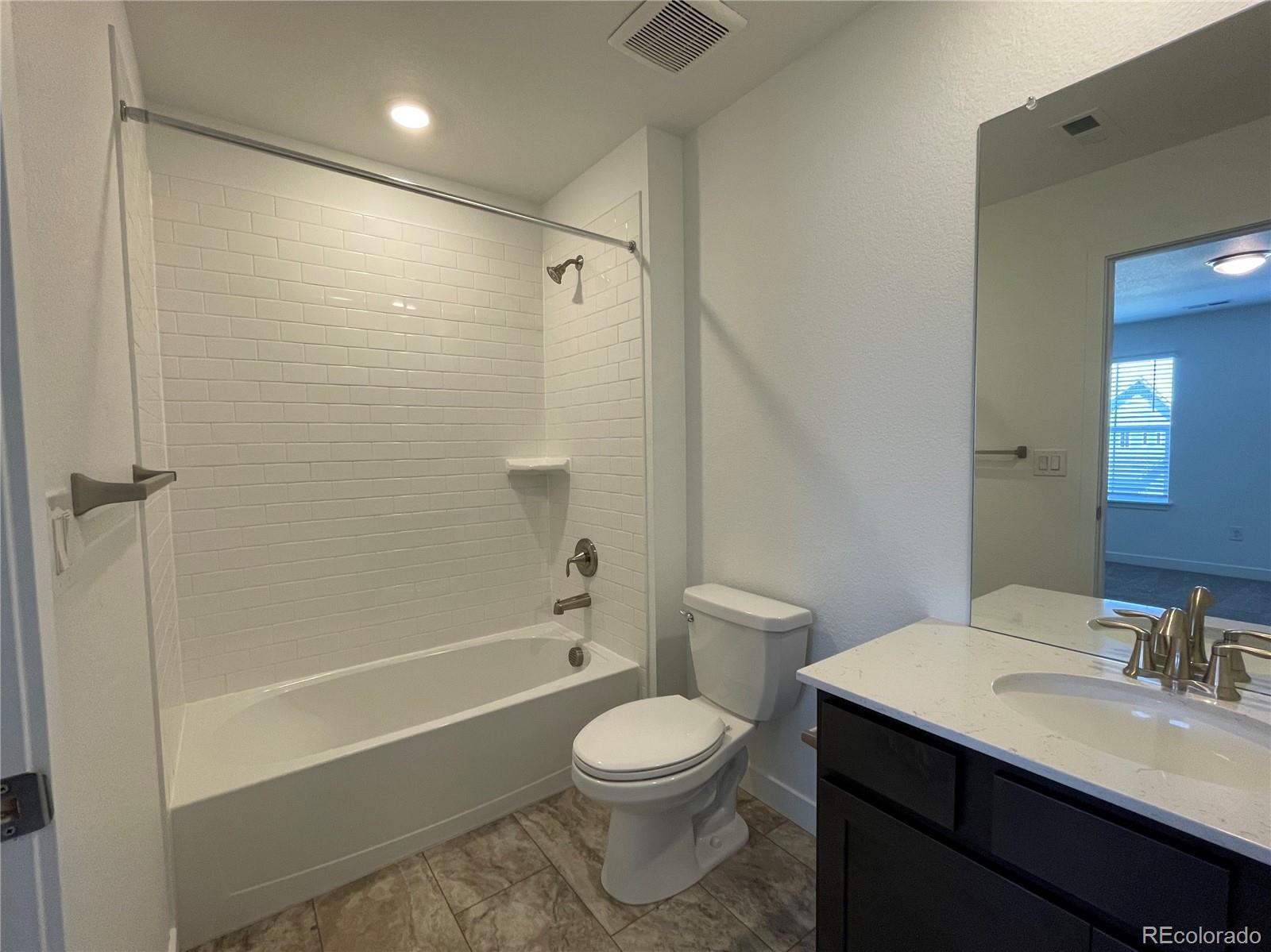 4598 Windmill Drive Brighton, CO 80601 - Photo 9 of 21 a bathroom with a sink a toilet and shower