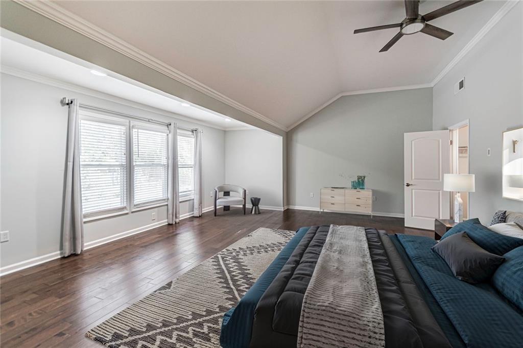 1892 Terry Mill Road Southeast Atlanta, GA 30316 - Photo 15 of 25 a large bedroom with a bed and wooden floor