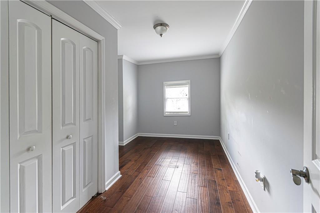 1892 Terry Mill Road Southeast Atlanta, GA 30316 - Photo 18 of 25 an empty room with wooden floor and windows