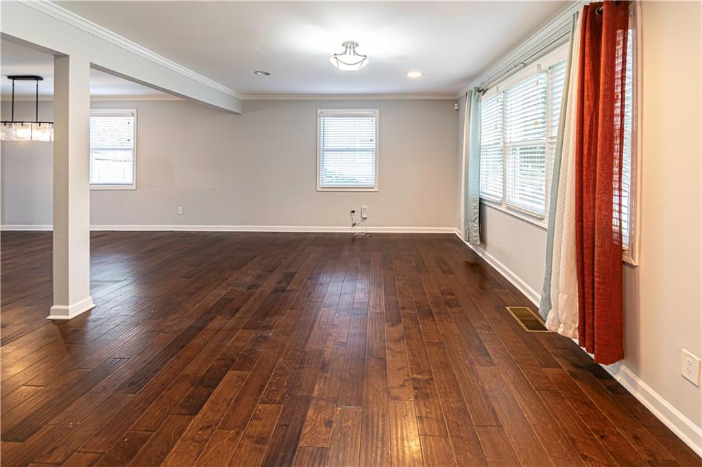 1892 Terry Mill Road Southeast Atlanta, GA 30316 - Photo 3 of 25 wooden floor in an empty room with a window