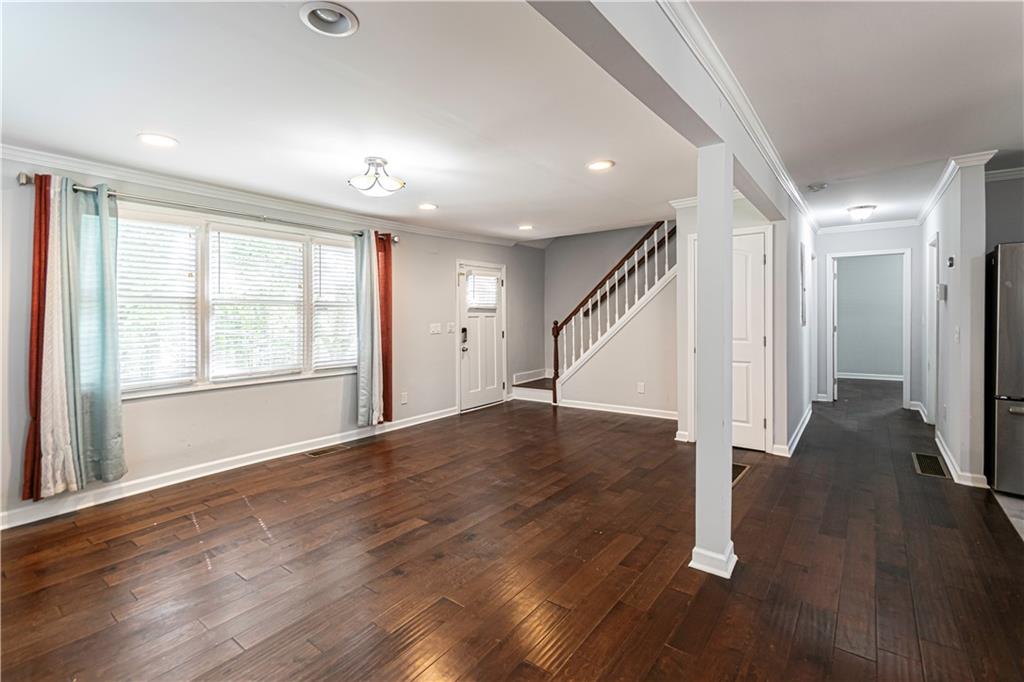 1892 Terry Mill Road Southeast Atlanta, GA 30316 - Photo 4 of 25 an empty room with wooden floor and windows