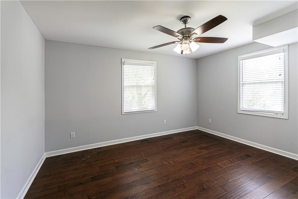 1892 Terry Mill Road Southeast Atlanta, GA 30316 - Photo 9 of 25 an empty room with wooden floor window and ceiling fan
