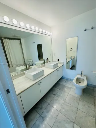 a bathroom with a double vanity sink and a mirror