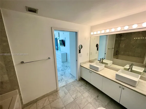 a bathroom with a double vanity sink and mirror