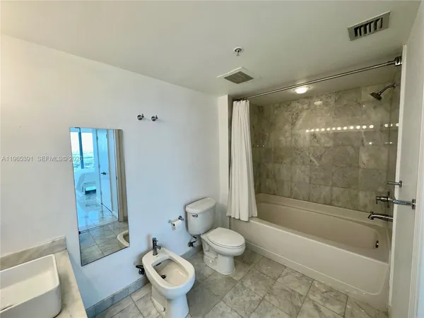 a bathroom with a shower and a toilet
