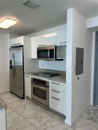 a kitchen with stainless steel appliances granite countertop a stove and a refrigerator