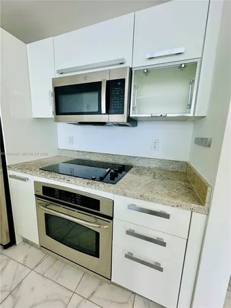 a kitchen with a stove and a microwave