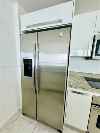 a bathroom with a granite countertop shower and a sink