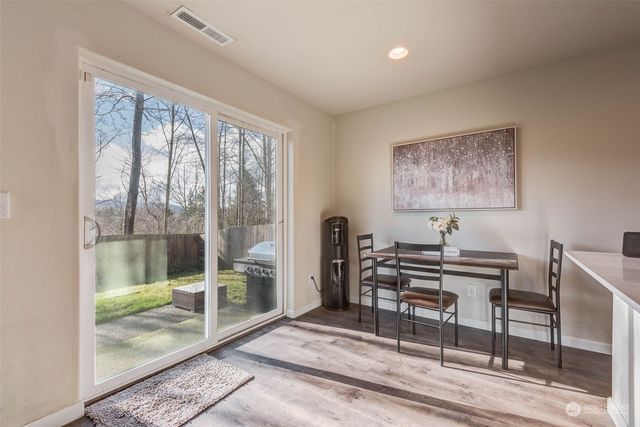 a kitchen with stainless steel appliances a sink a stove a microwave a sink a refrigerator and cabinets