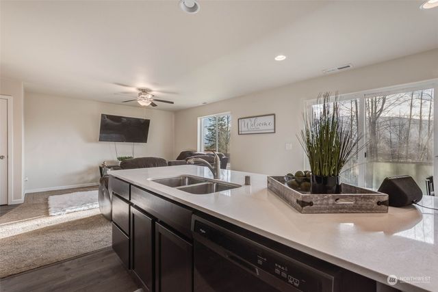 a view of staircase with lots of frames on wall and a view of stairs