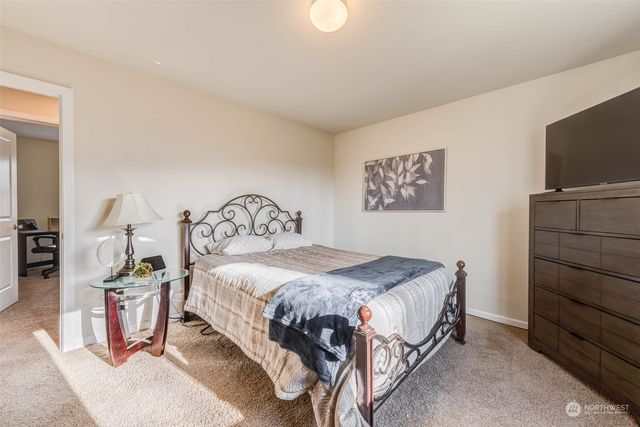 a bedroom with a bed and a flat tv screen