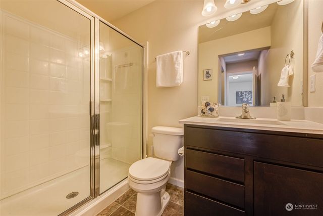 a bathroom with a toilet a sink and a mirror