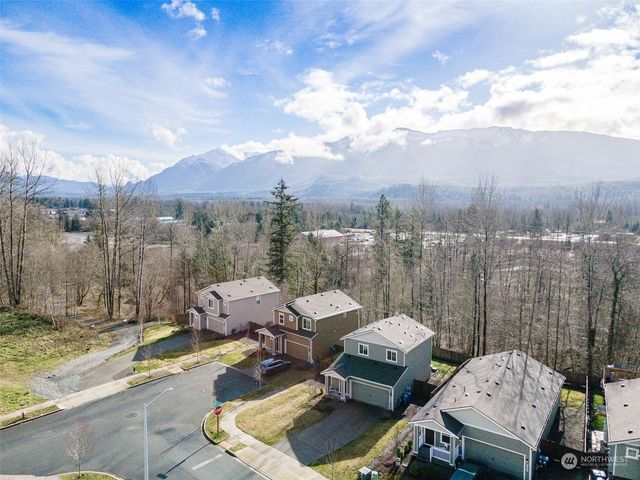 a backyard of a house with table and chairs