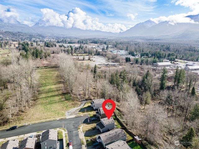 a view of a house with backyard and sitting area