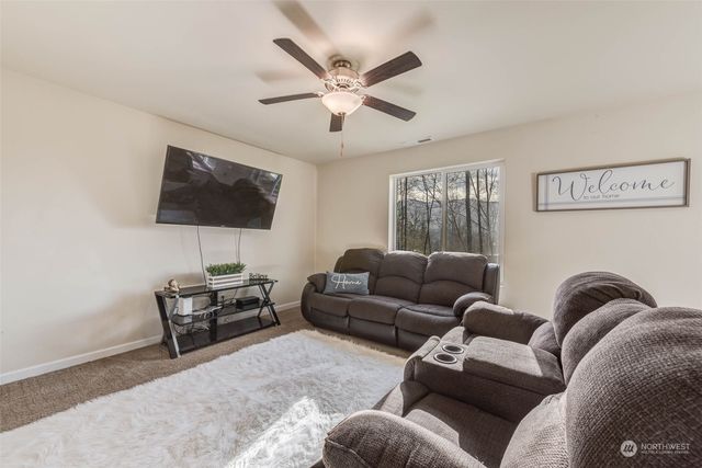 a bedroom with a bed couch and a flat screen tv