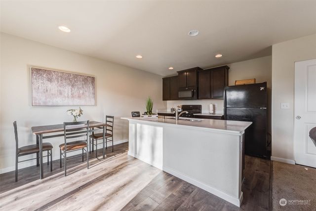 a view of a workspace with furniture and a gate