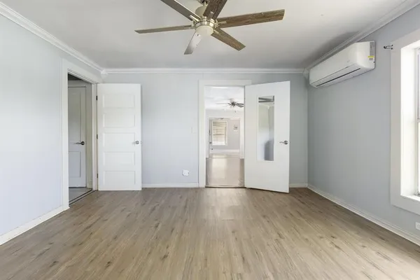 wooden floor in an empty room with a window