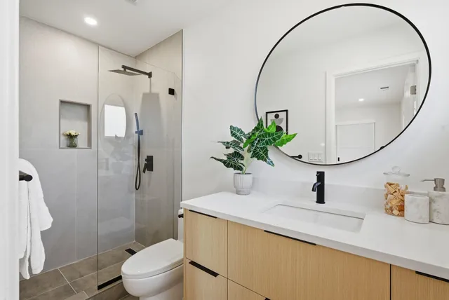 a bathroom with a sink toilet and shower