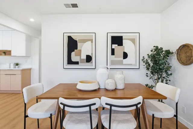 a dining room with furniture and wooden floor