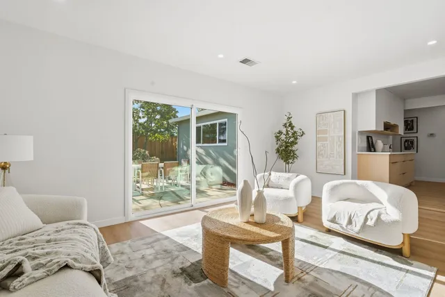 a bedroom with furniture and a large window